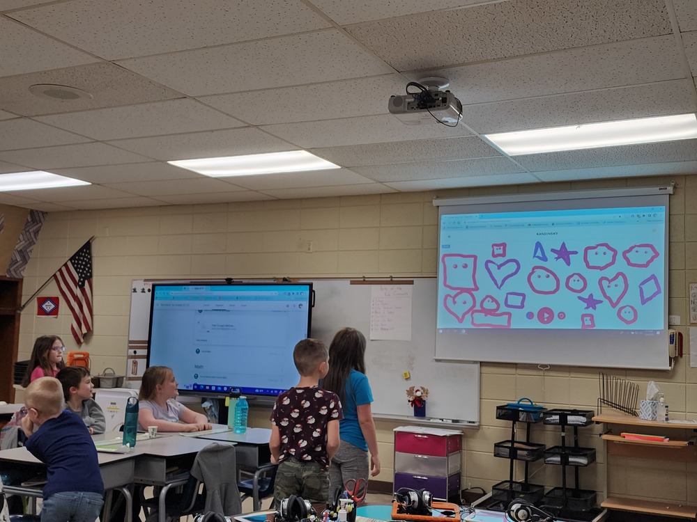 First graders learning about the Chrome Music Lab which lets students draw pictures and transforms their drawings into music.