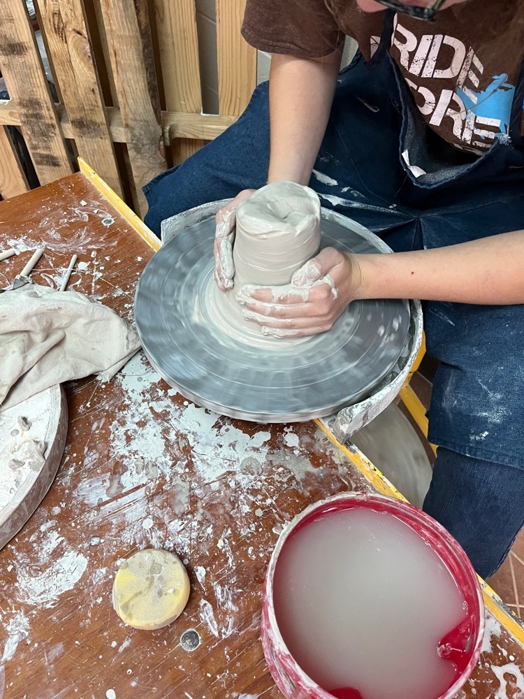 Trying the pottery wheel for the first time.  