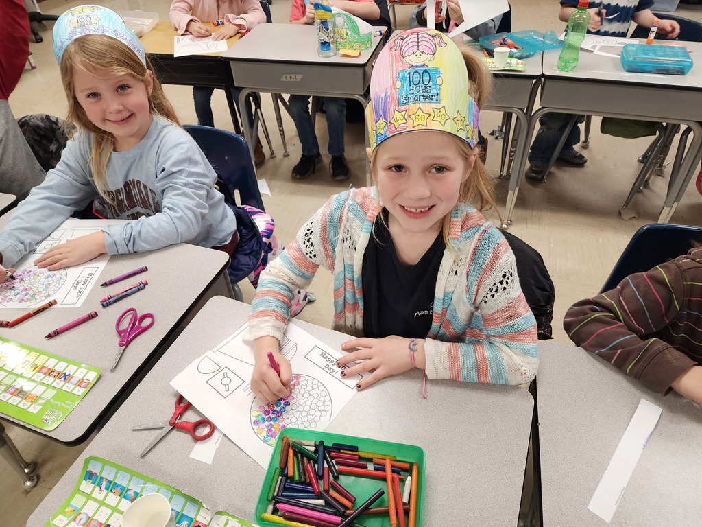 Students wearing their 100th day of school crowns and coloring 100 gumballs.