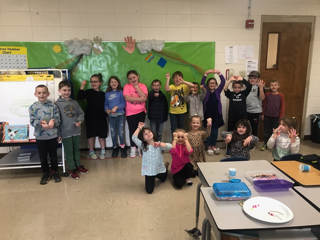 Mrs. Grass' class showing off their 100th day of school bracelets.