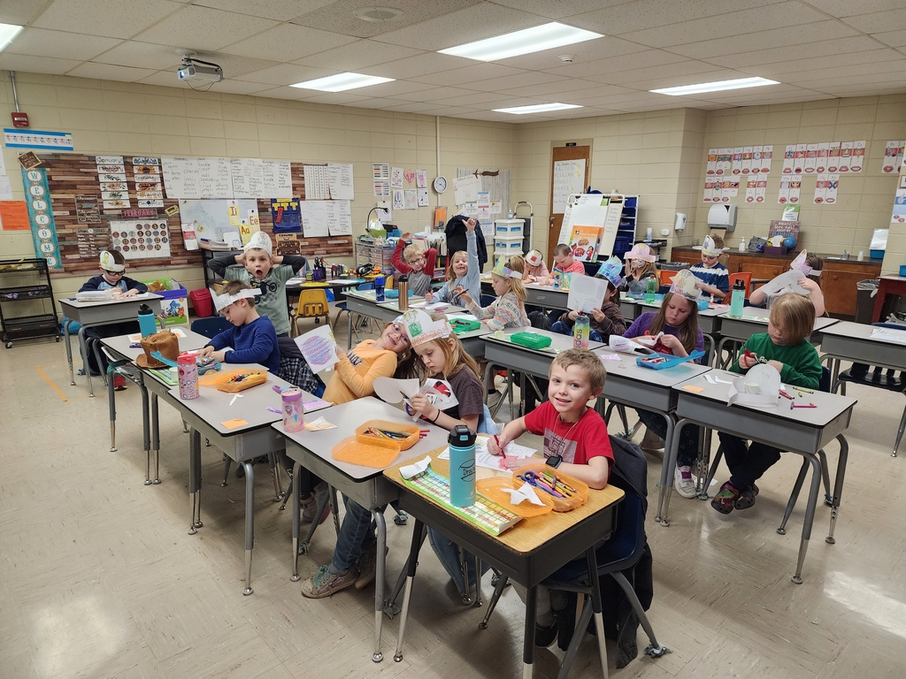 Miss McIntosh's class working on putting together their 100th day of school crowns.